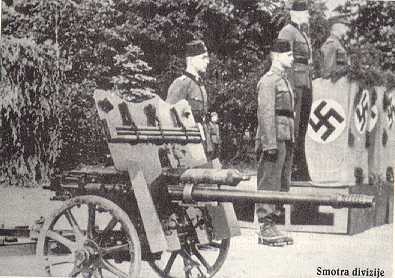 Bosnian Muslim 13th Waffen SS Handzar volunteer troops at attention with artillery guns.